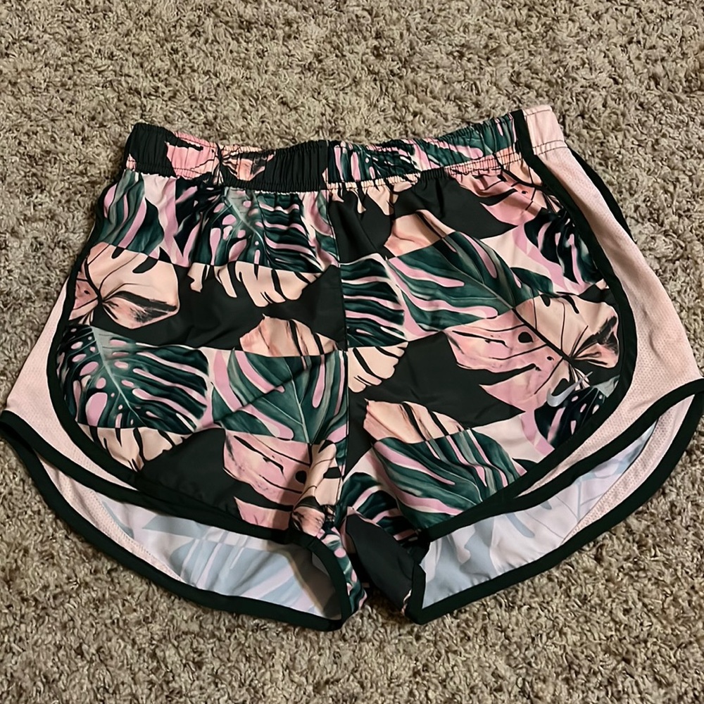 Like new, Nike dry-fit size small running shorts in a tropical print.